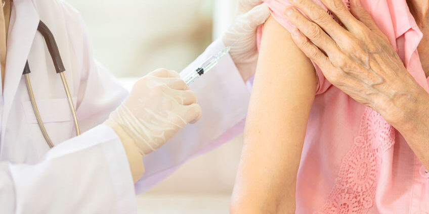 Close up,asian female doctor with syringe doing injection vaccin