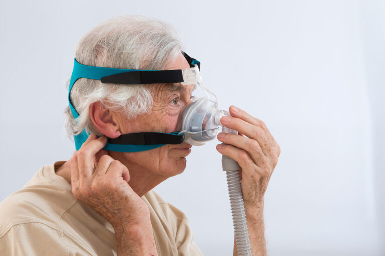 SLEEP APNEA SYNDROME -Senior man using CPAP machine